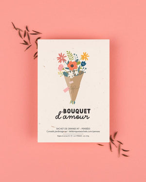 La Fabrique à Sachets - Liebesstrauß-Tütchen mit Stiefmütterchensamen, zeigt Blumenbouquet-Illustration, umgeben von gestreuten Samen, auf einer warmen Unterlage.