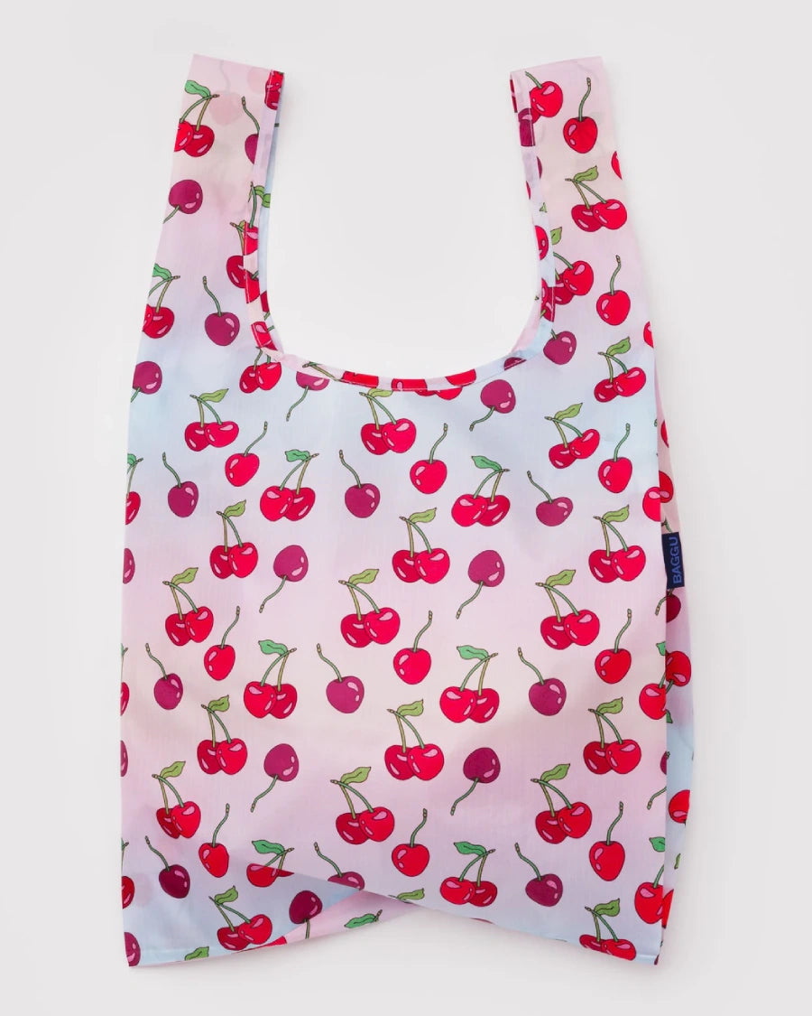 Standard Baggu Einkaufsbeutel Cherries, ein leichter, robuster Beutel mit Kirschenmotiv auf rosa Hintergrund, aus recyceltem Ripstop-Polyester, ideal für vielseitige, nachhaltige Alltagsnutzung.