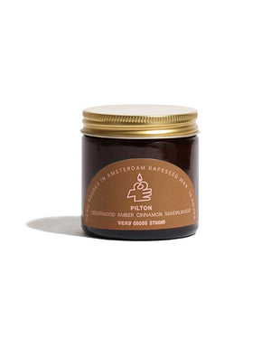 Pilton Duftkerze 60ml in einem bernsteinfarbenen Glas mit goldenem Schraubdeckel, handgegossen in Amsterdam aus Rapswachs, mit Noten von Sandelholz, Amber und Zimt. Brenndauer: 15 Stunden.